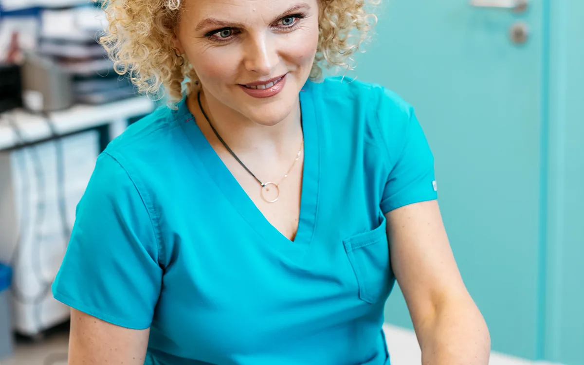 Joanna Stodolna-Tukendorf przy nodze pacjentki leżącej na stole zabiegowym